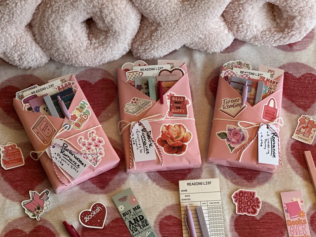 Three Valentine's Day themed wrapped books with cute book accessories